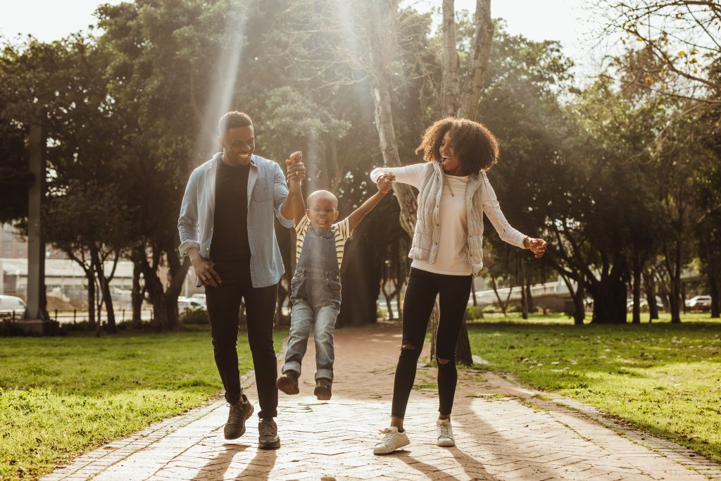 Young family walking together in a park