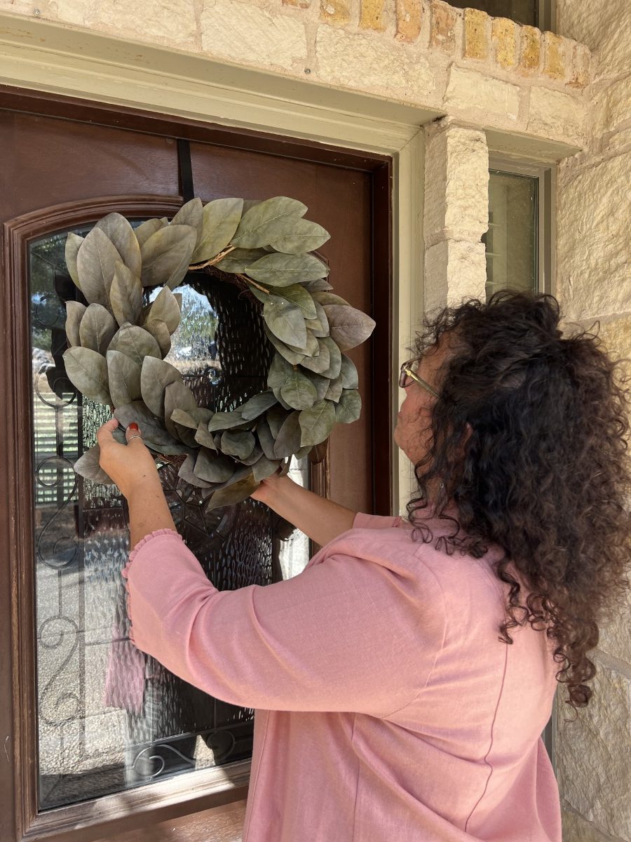 Placing Magnolia Wreath on Door
